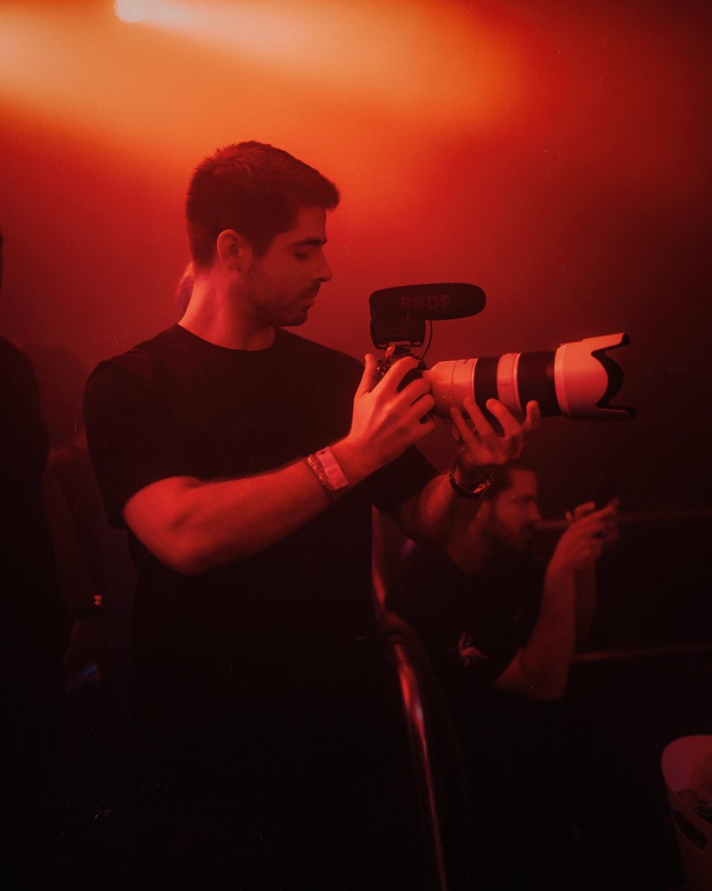 Francisco Correia, founder of Craft Frame Media, filming at an event with a camera and microphone